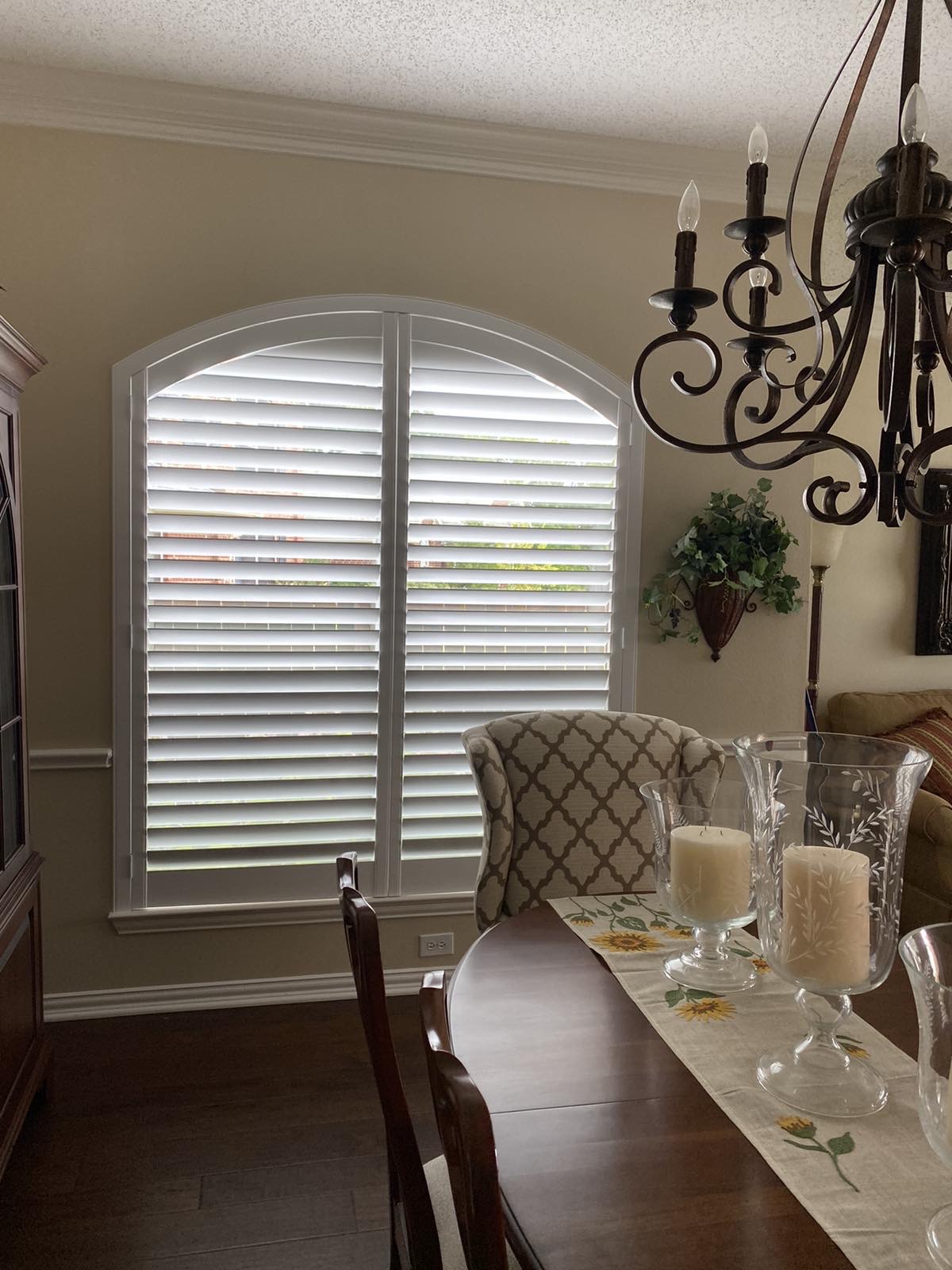 Arched plantation shutter in an elegant dining room